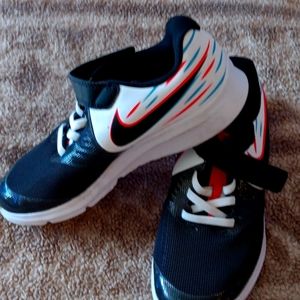 Kids Nike gym shoes size  1 and a half white black and teal and neon red lines